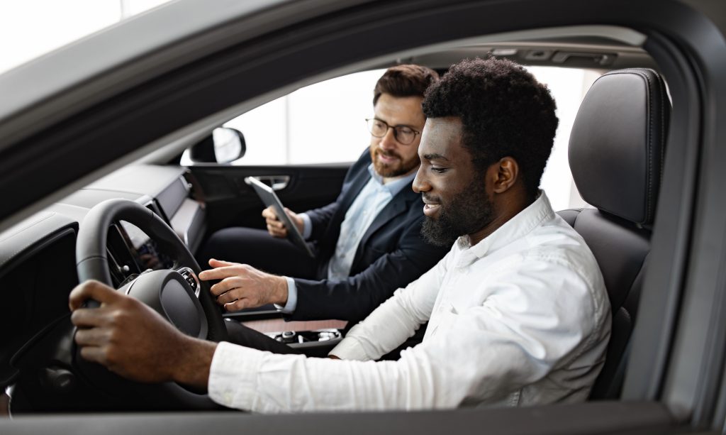 A new car buyer inside a new car