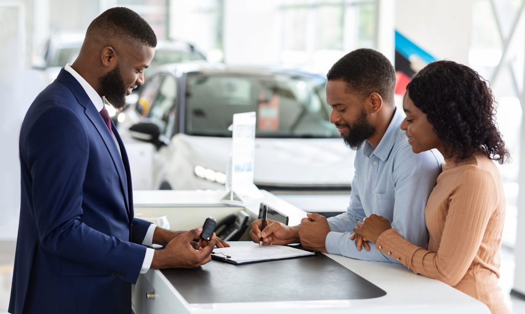 A black african man going vehicle finance paperwork