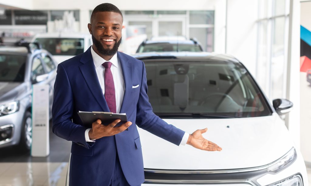 A car salesman at the dealership