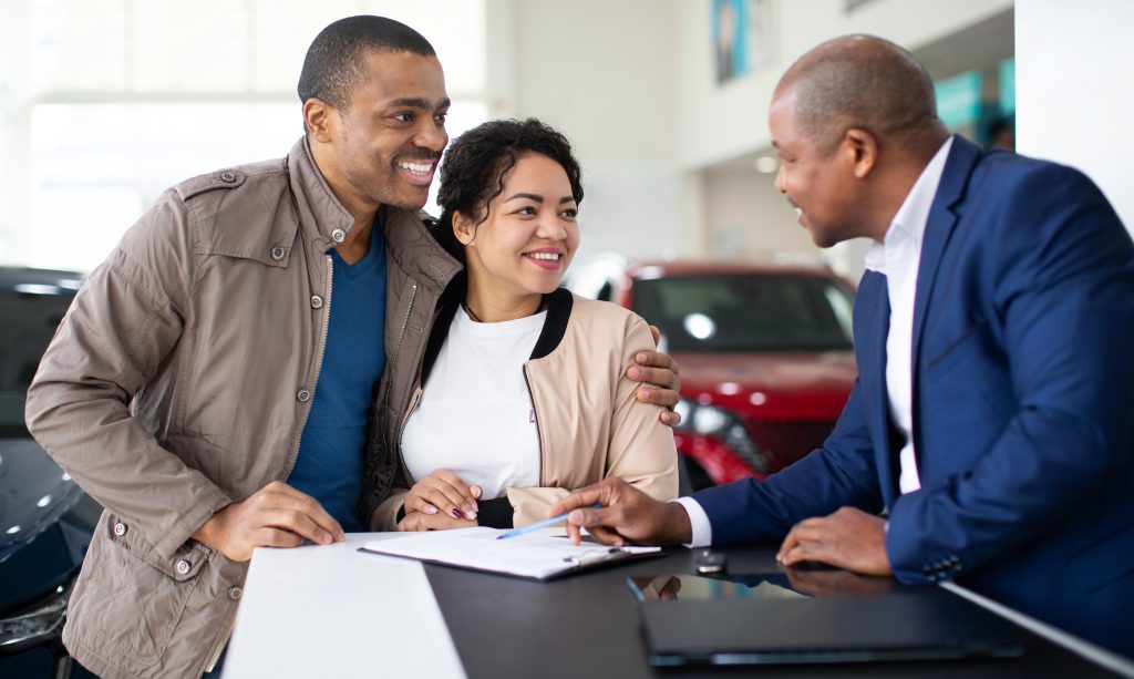 A couple about to sign a vehicle agreement